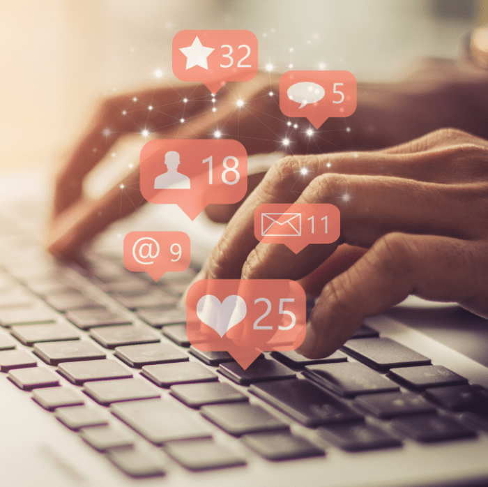 The sun glows behind a pair of hands resting on a Macbook keyboard. Social media likes and icons are superimposed floating over the fingers